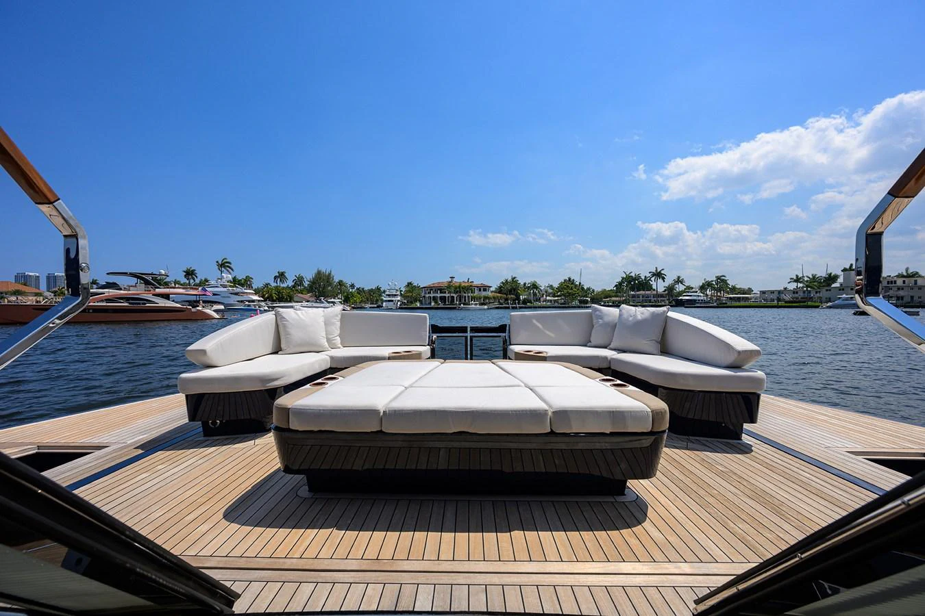The aft deck features luxurious sun loungers and comfortable seating with a stunning waterfront view. aboard LAZZARA LSX 67 Yacht for Sale