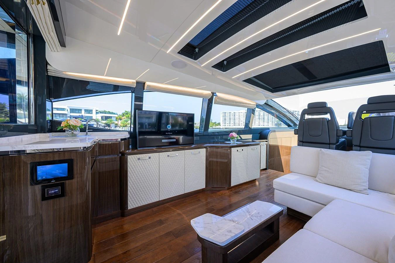 The yacht's salon features luxurious seating, a modern entertainment system, and elegant finishes. aboard LAZZARA LSX 67 Yacht for Sale