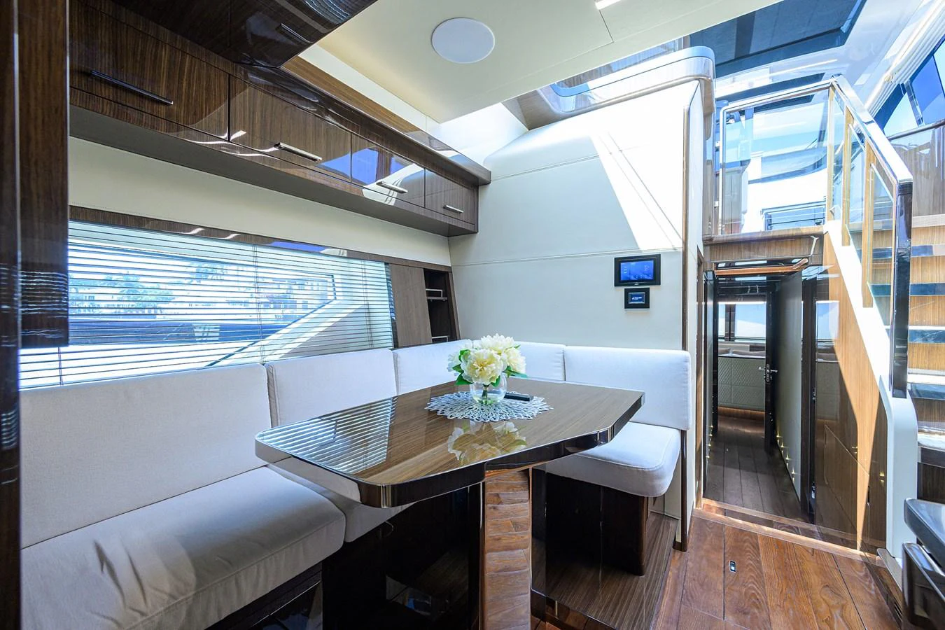 The yacht's dining area features a sleek table with comfortable seating and elegant decor. aboard LAZZARA LSX 67 Yacht for Sale