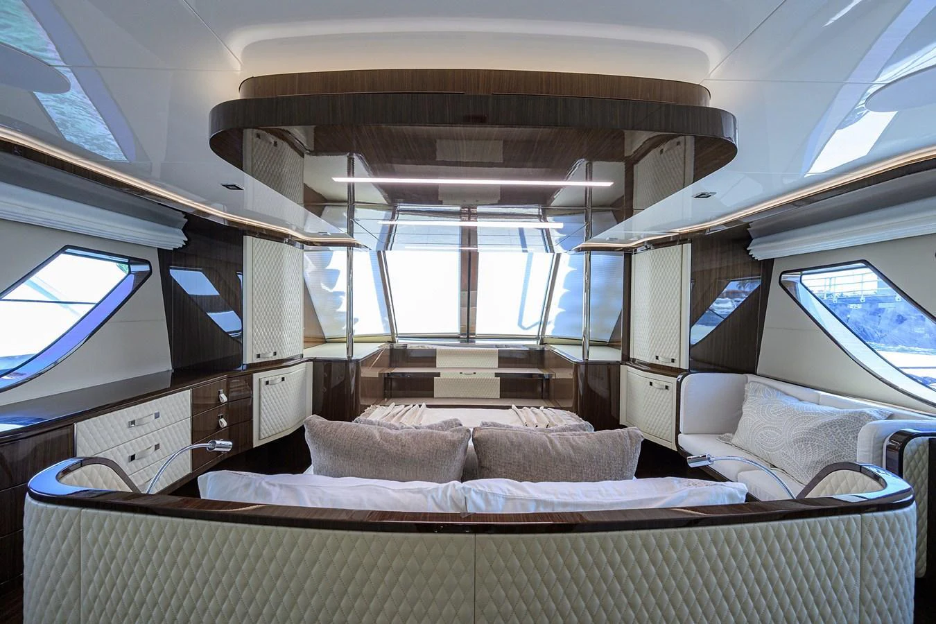 The yacht's salon features luxurious seating with panoramic windows offering stunning views. aboard LAZZARA LSX 67 Yacht for Sale