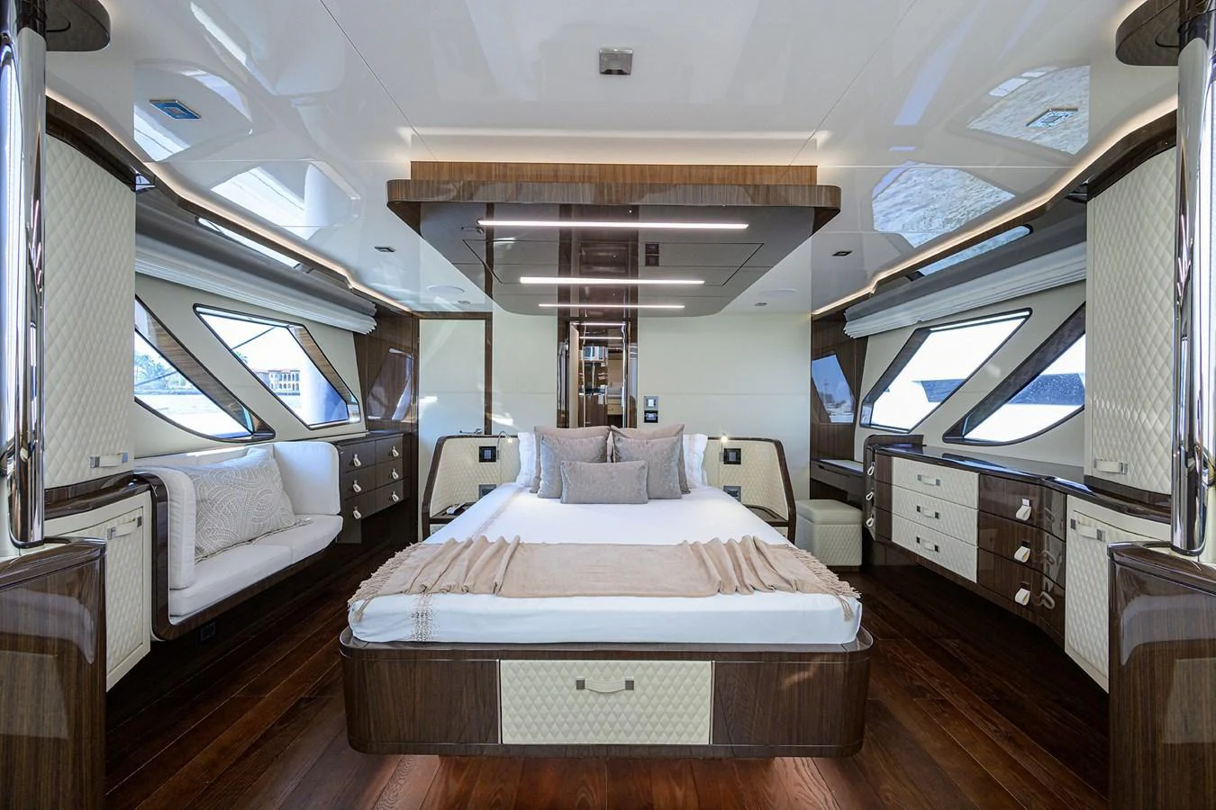 The master stateroom offers a luxurious and spacious retreat with elegant wood finishes and ample natural light. aboard LAZZARA LSX 67 Yacht for Sale