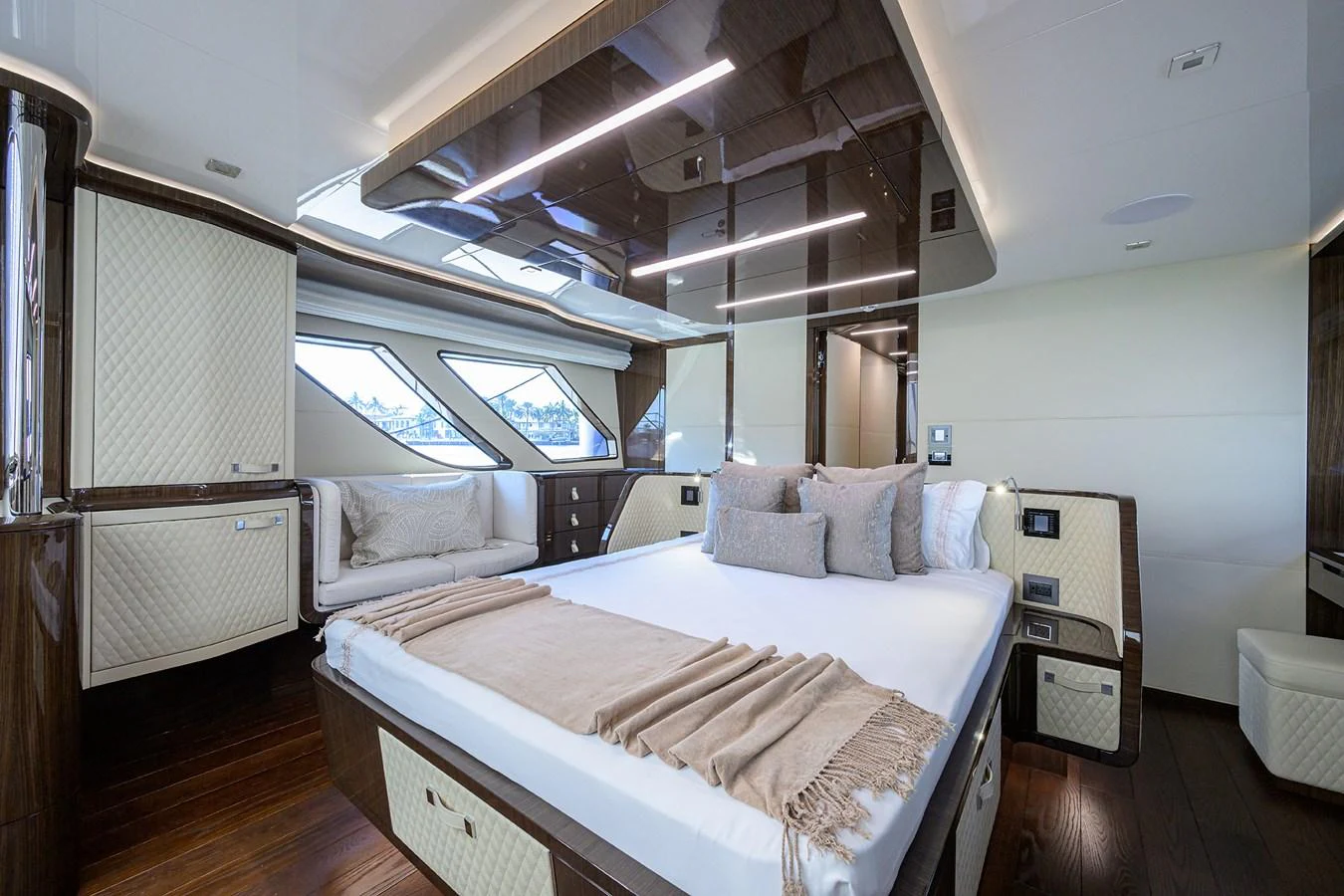 The master stateroom features a luxurious bed with elegant decor and ample natural light. aboard LAZZARA LSX 67 Yacht for Sale