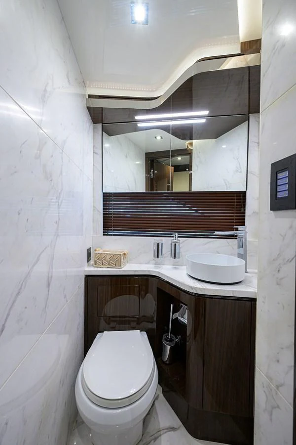 The yacht's head features a sleek, modern design with luxurious marble finishes and high-end fixtures. aboard LAZZARA LSX 67 Yacht for Sale