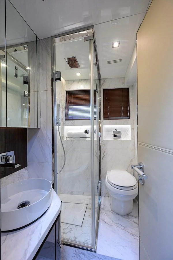 The yacht's bathroom features elegant marble surfaces and modern fixtures. aboard LAZZARA LSX 67 Yacht for Sale