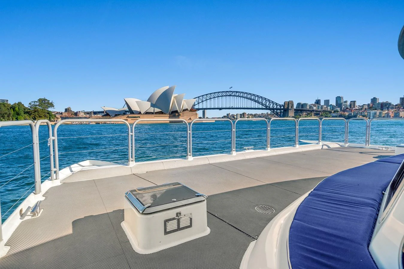 The yacht's deck offers a stunning view of the Sydney Opera House and Harbour Bridge. aboard COAST Yacht for Sale