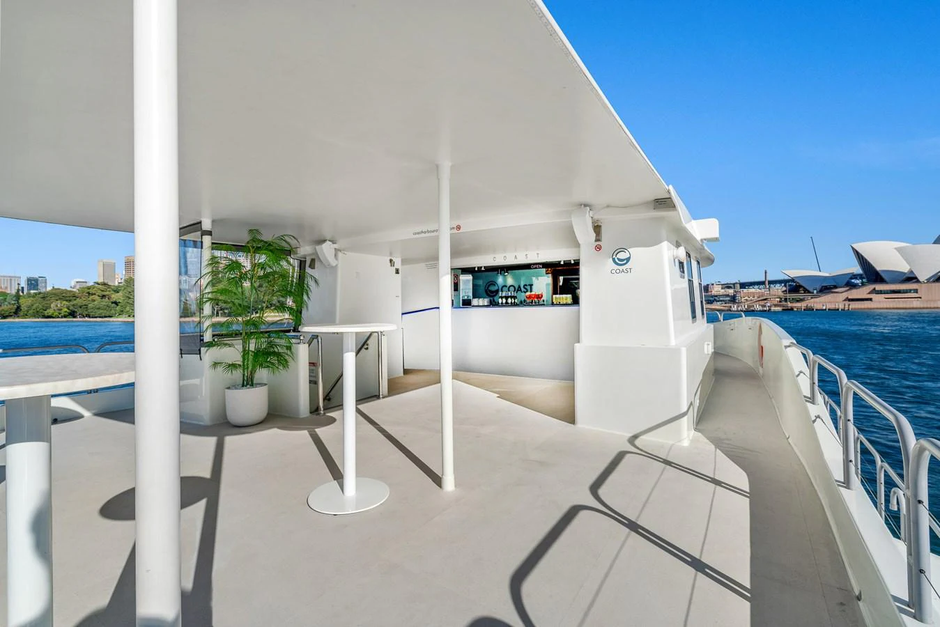 The aft deck offers a spacious and open area with a view of the water and nearby landmarks. aboard COAST Yacht for Sale