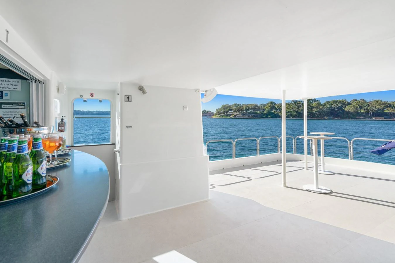 The aft deck offers a spacious and open area with a bar and stunning views of the surrounding water. aboard COAST Yacht for Sale