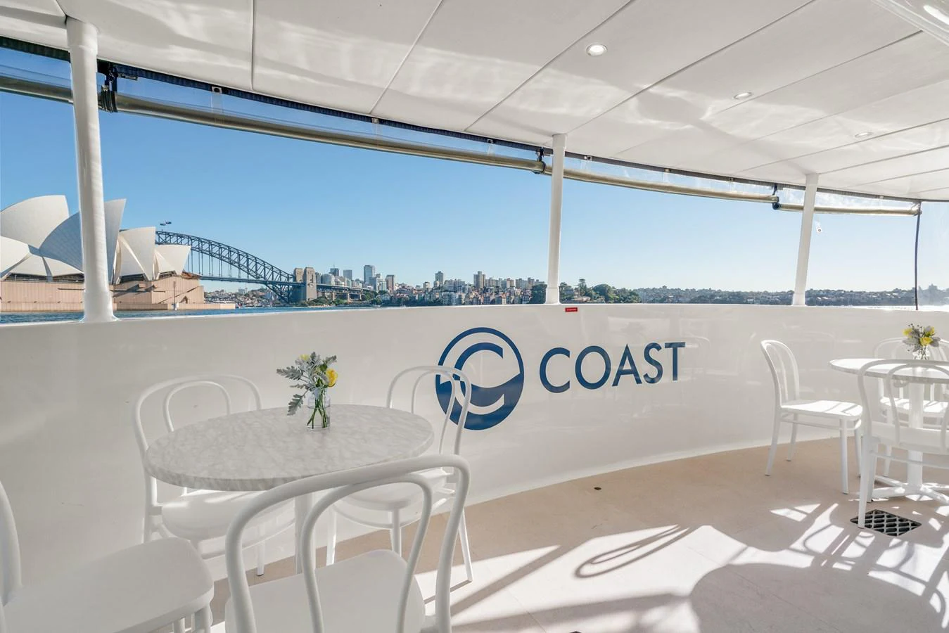 The aft deck offers a serene setting with a view of the Sydney Opera House and Harbour Bridge. aboard COAST Yacht for Sale