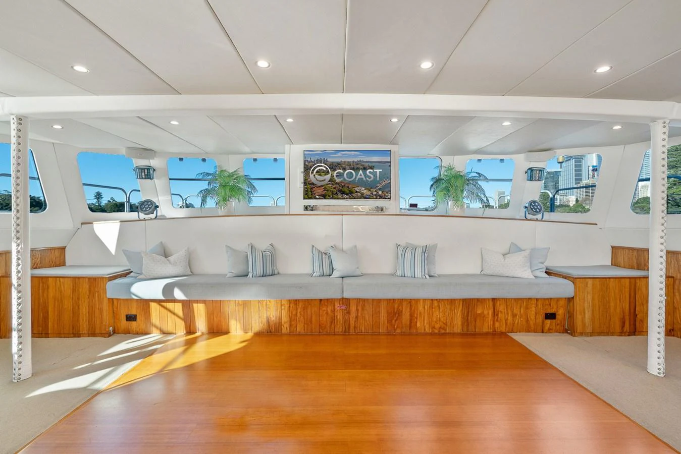 The salon offers a spacious and inviting area with ample seating and large windows for natural light. aboard COAST Yacht for Sale