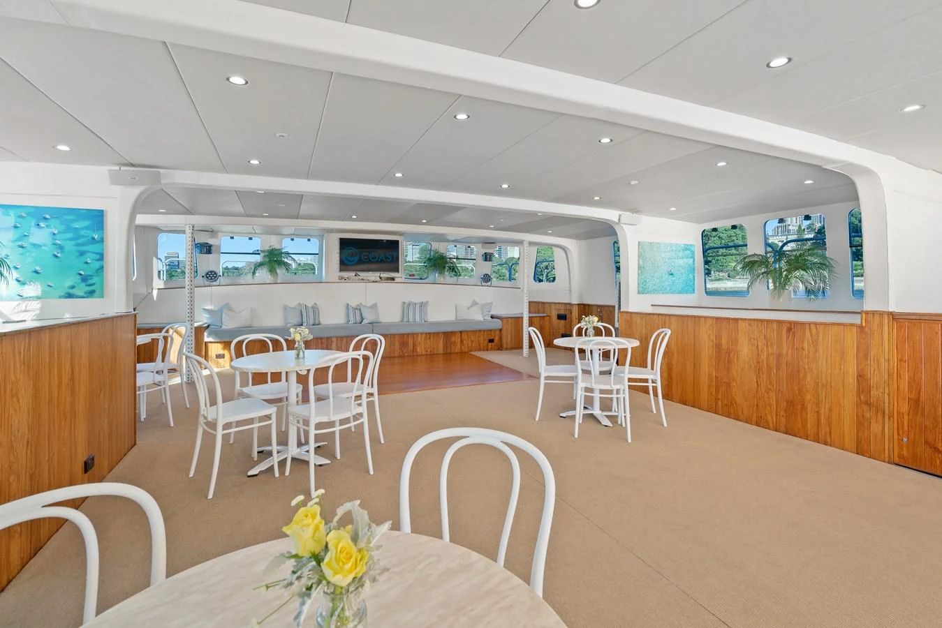 The spacious interior dining area features elegant seating and large windows for panoramic views. aboard COAST Yacht for Sale