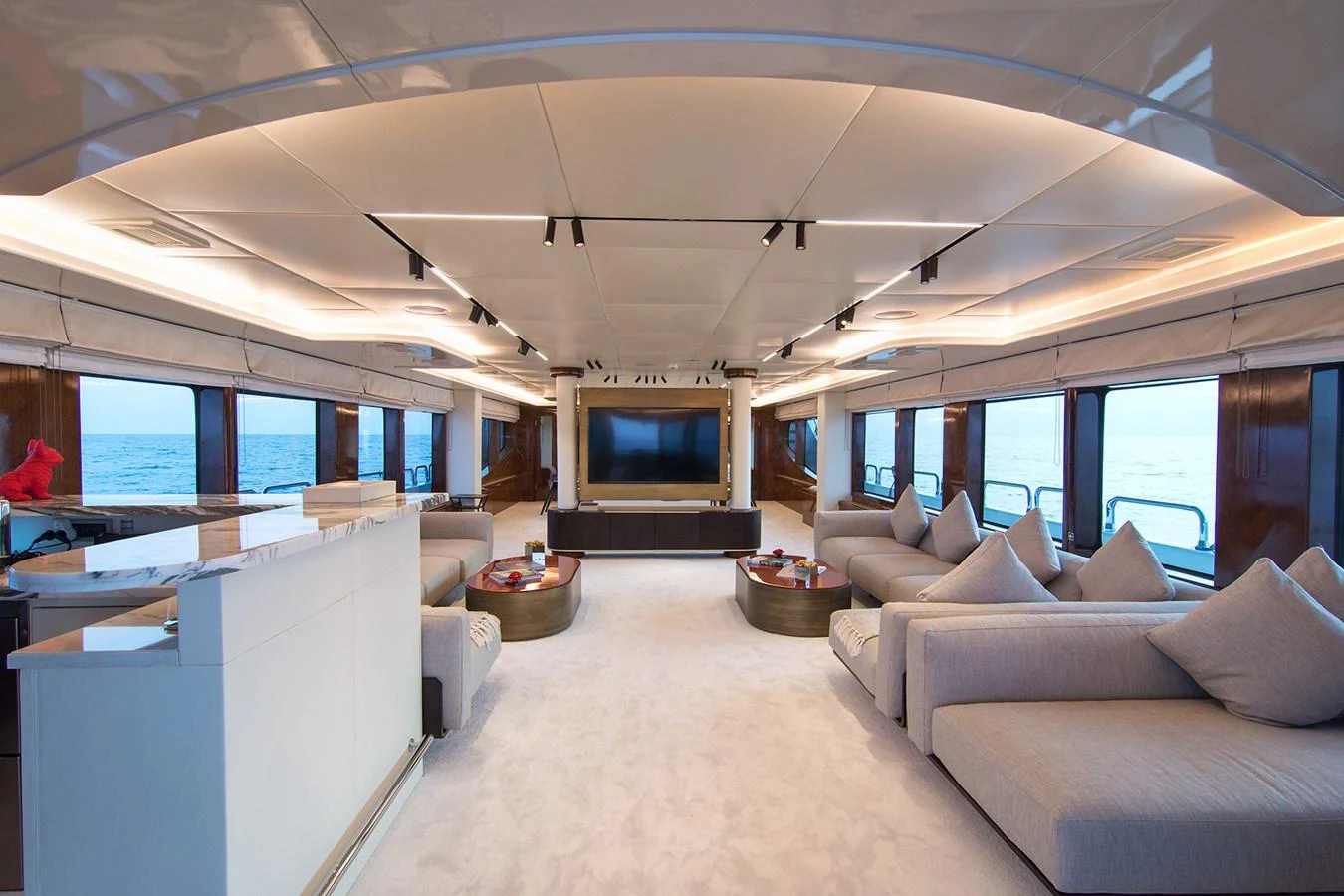 a living room with a large screen aboard HALLO Yacht for Sale