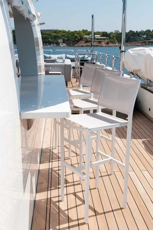 a white chair on a balcony aboard HALLO Yacht for Sale