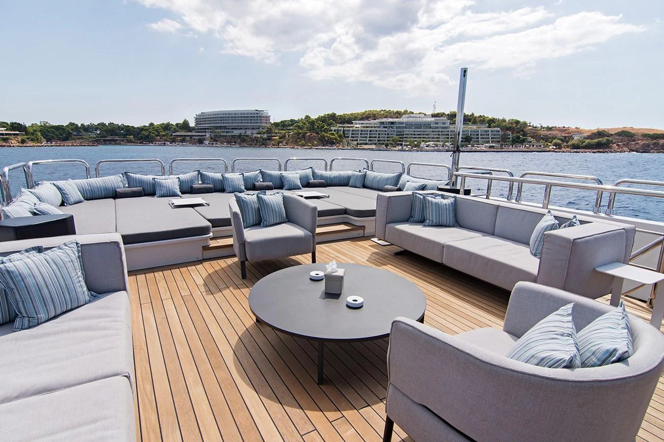 a deck with a table and chairs aboard HALLO Yacht for Sale
