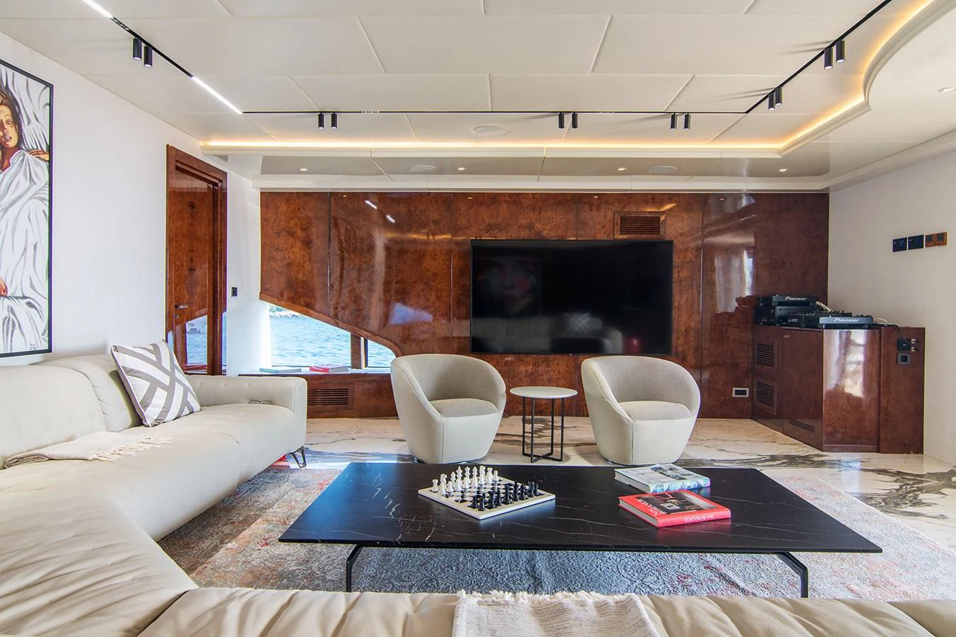 a living room with a fireplace aboard HALLO Yacht for Sale