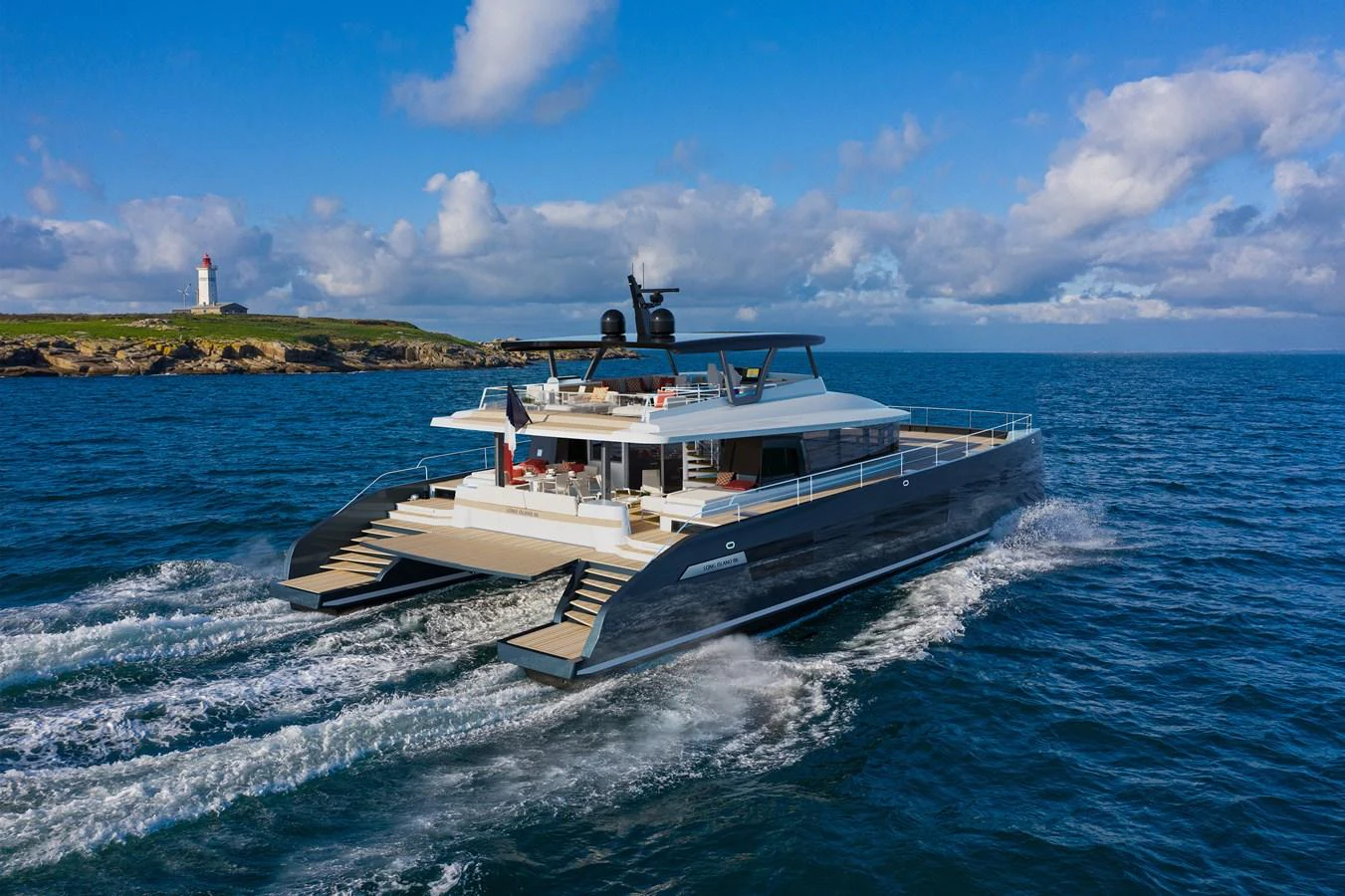 A sleek and modern yacht cruises through the open sea under a bright, partly cloudy sky. aboard LONG ISLAND Yacht for Sale