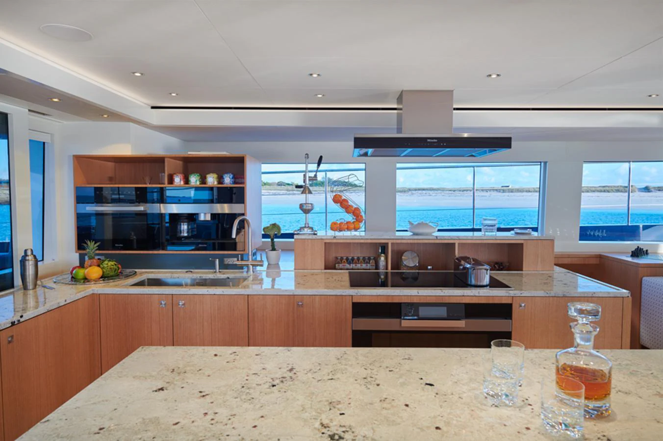 The galley features modern appliances and a spacious countertop with a view of the sea. aboard LONG ISLAND 78 Yacht for Sale