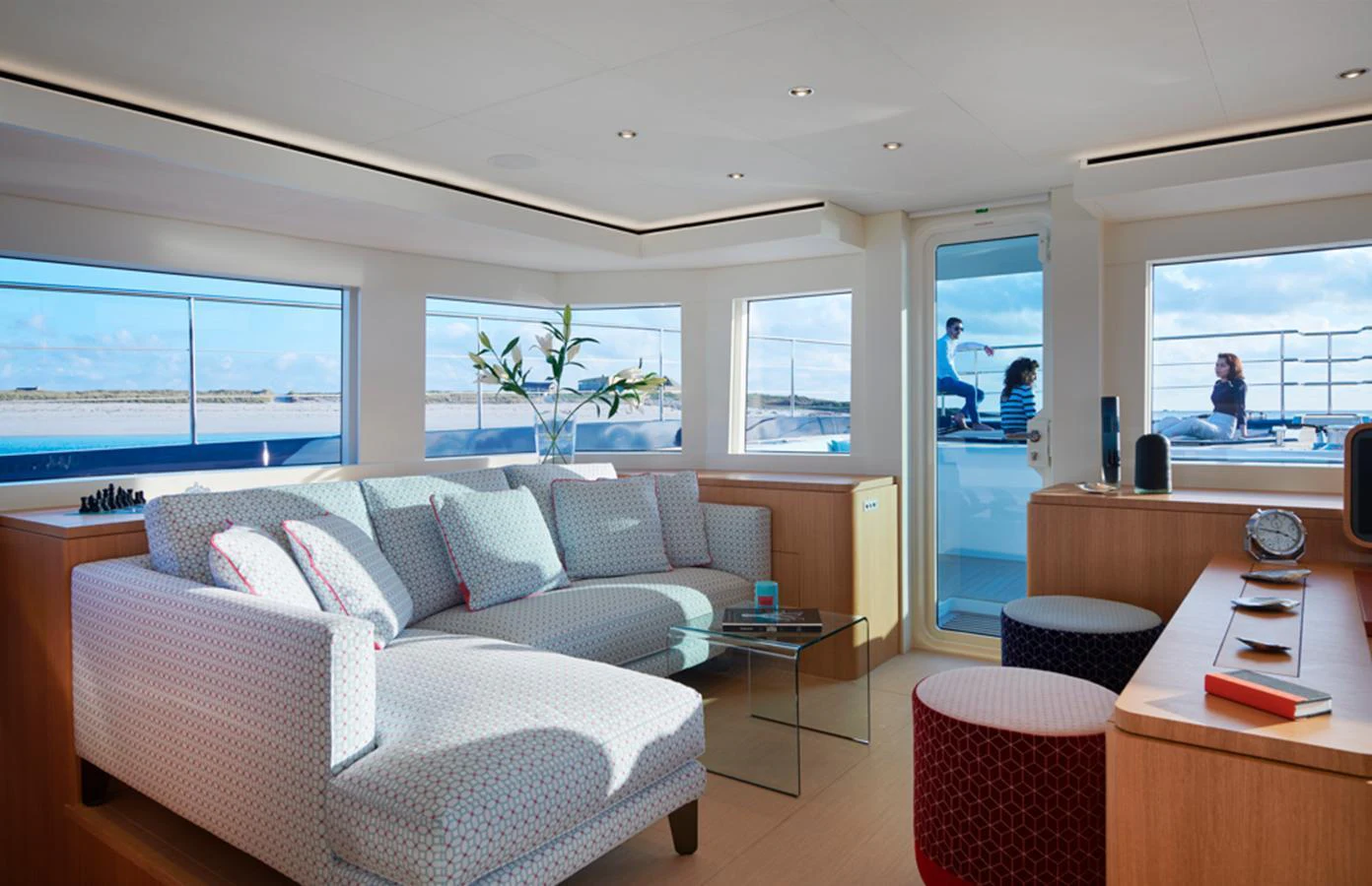The yacht's salon is bright and inviting, featuring comfortable seating and large windows with scenic views. aboard LONG ISLAND 78 Yacht for Sale