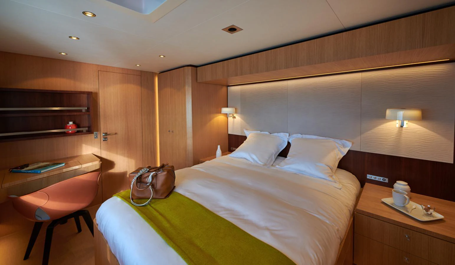 A luxurious stateroom featuring a large bed with elegant bedding and warm lighting. aboard LONG ISLAND 78 Yacht for Sale