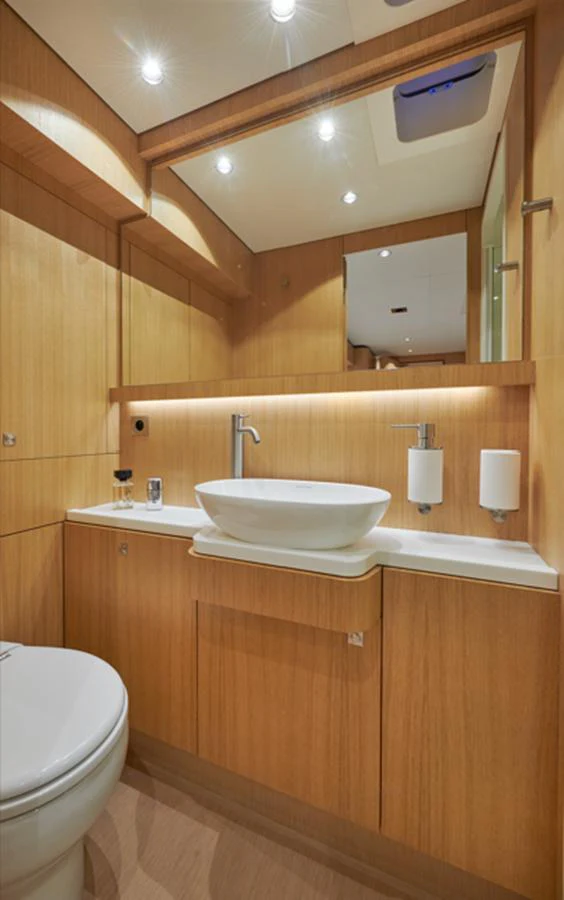 The yacht's bathroom features modern fixtures and warm wooden accents. aboard LONG ISLAND 78 Yacht for Sale
