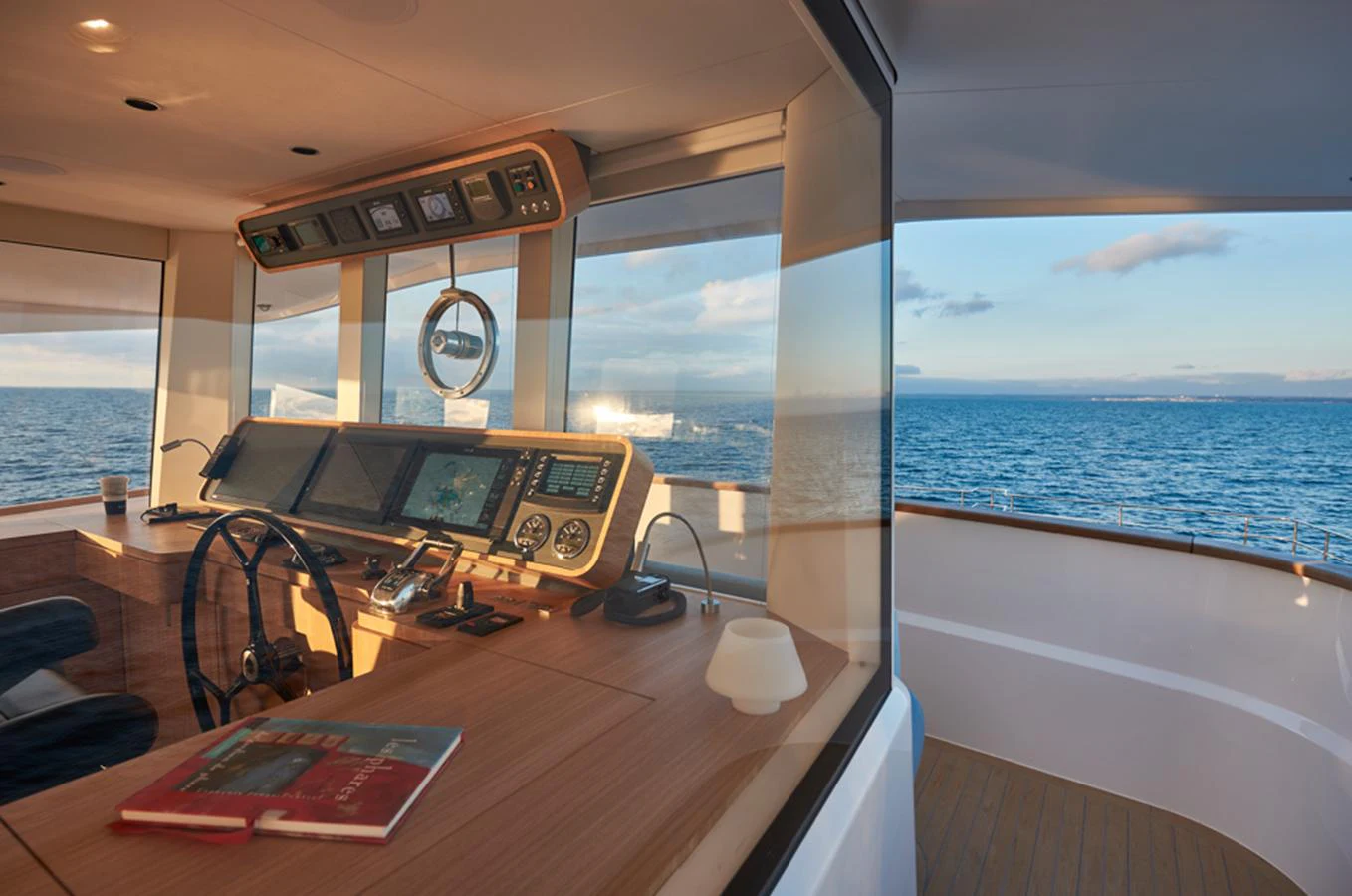 The helm station offers a panoramic view of the open sea, blending advanced navigation technology with elegant design. aboard LONG ISLAND 78 Yacht for Sale