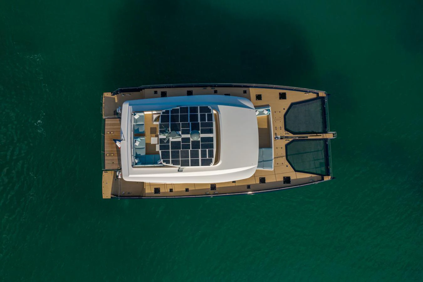 An aerial view of a modern yacht showcasing its sleek design and spacious deck layout. aboard LONG ISLAND 78 Yacht for Sale