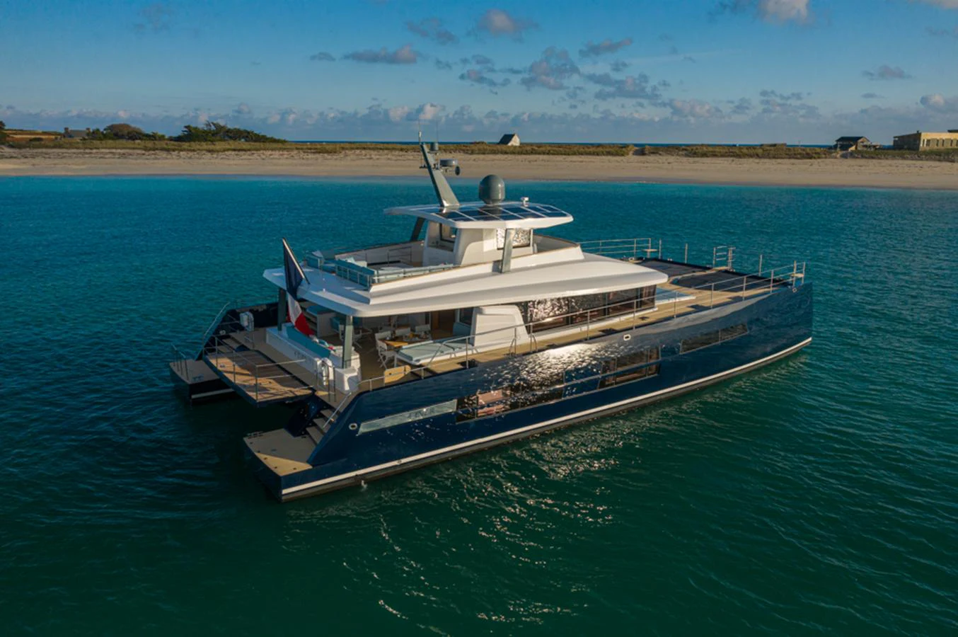 A sleek and modern yacht cruises gracefully on tranquil waters under a clear sky. aboard LONG ISLAND 78 Yacht for Sale