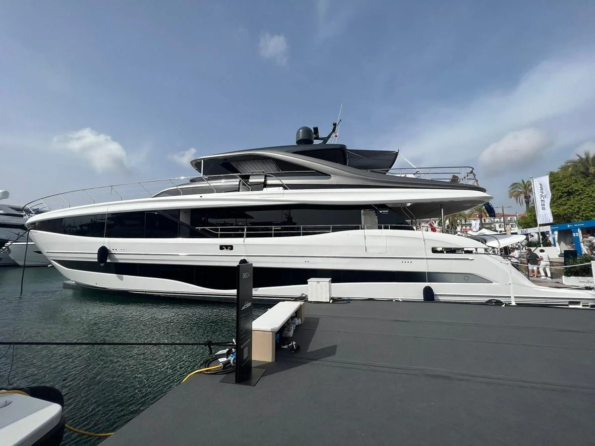 A sleek and modern yacht is docked at a marina, showcasing its elegant design and spacious decks. aboard LEILANI Yacht for Sale
