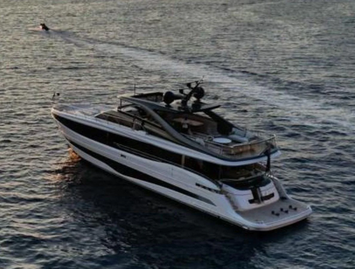 A sleek and modern yacht cruises gracefully on the open water at sunset. aboard LEILANI Yacht for Sale