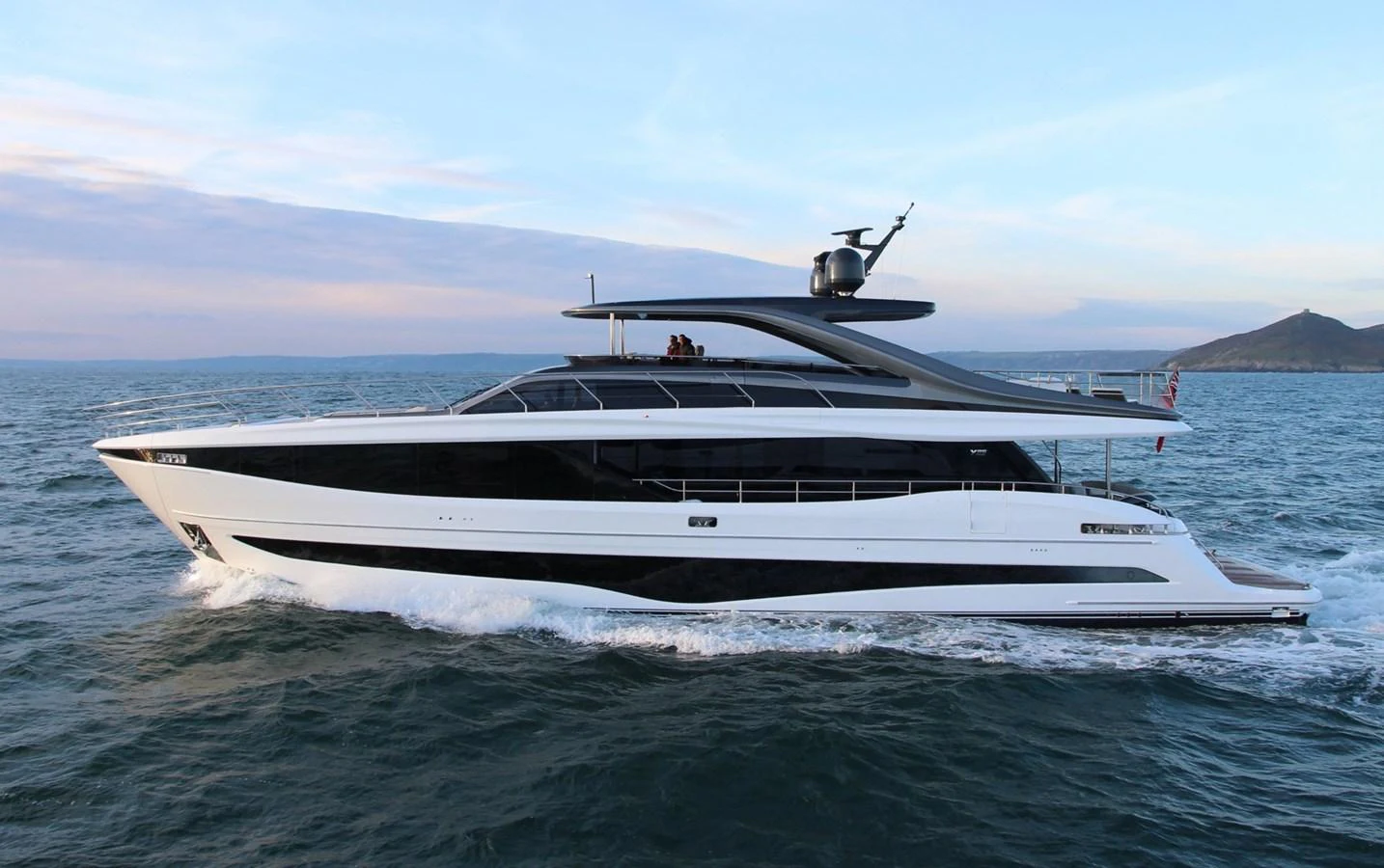 A sleek and modern yacht cruising on open waters with a stunning backdrop. aboard LEILANI Yacht for Sale