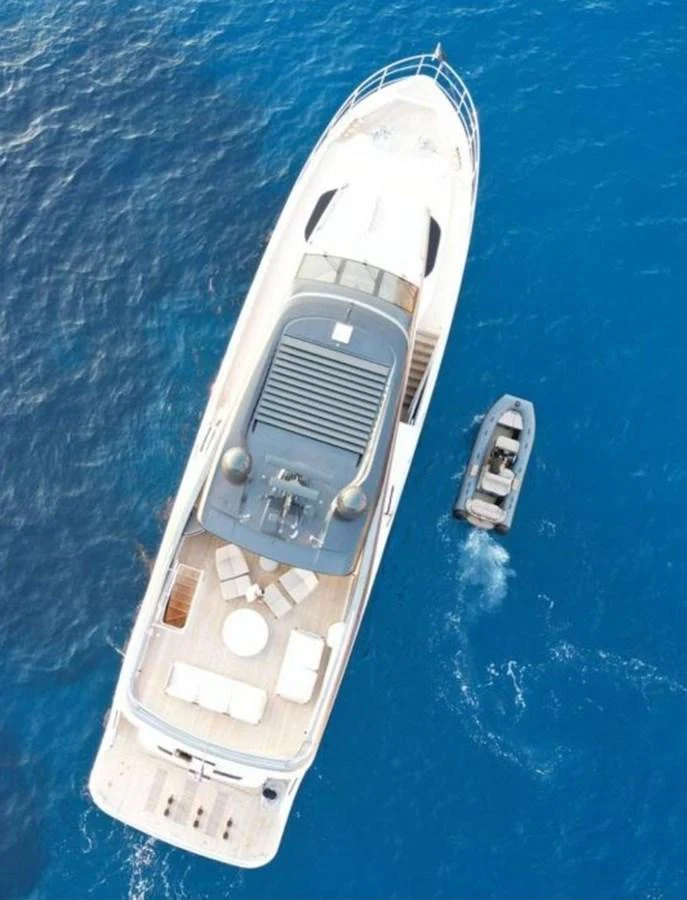Aerial view of a luxurious yacht with a tender alongside in clear blue waters. aboard LEILANI Yacht for Sale