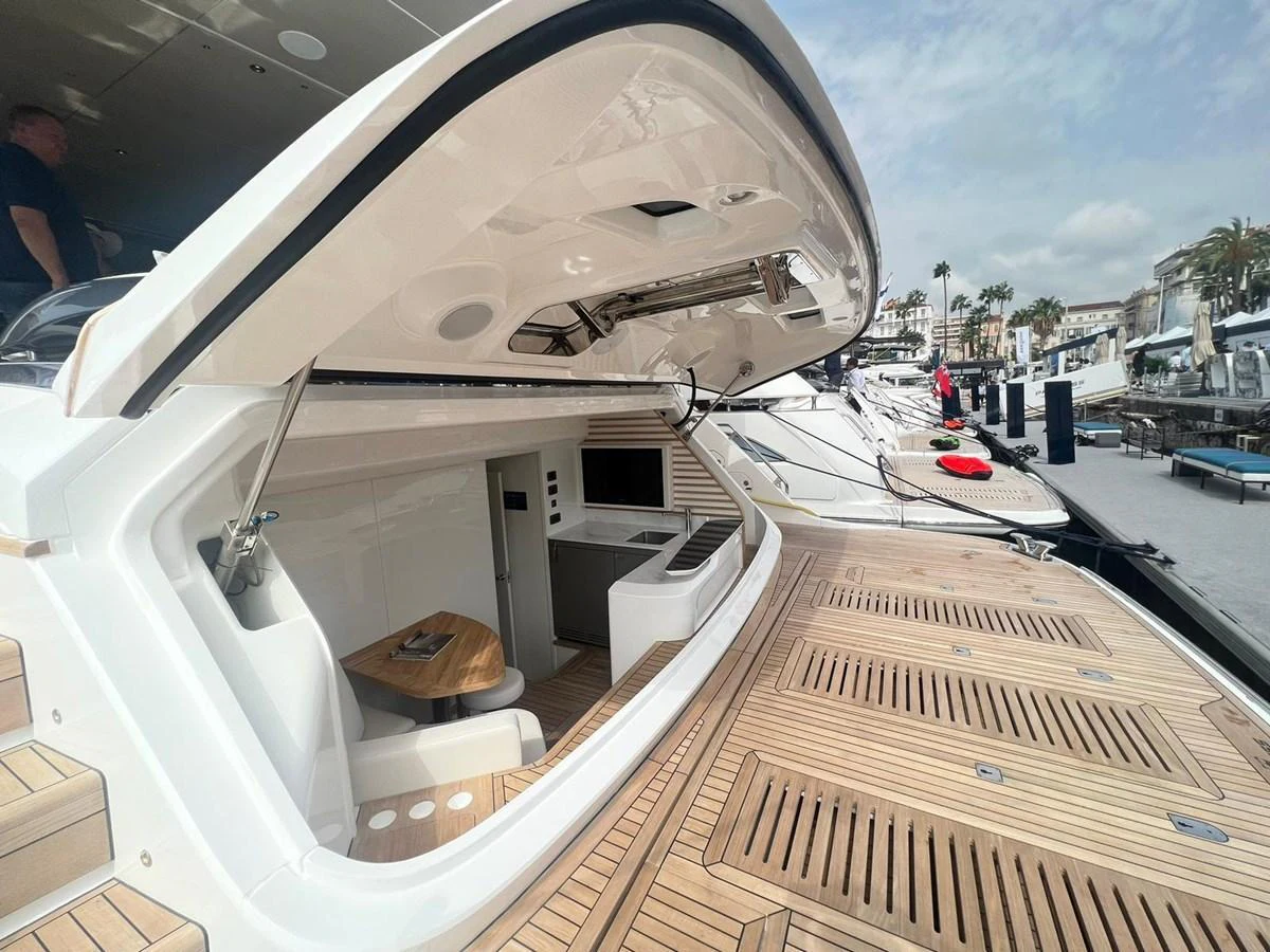 The yacht's aft deck features a spacious and inviting area with a fold-out section for relaxation and dining. aboard LEILANI Yacht for Sale