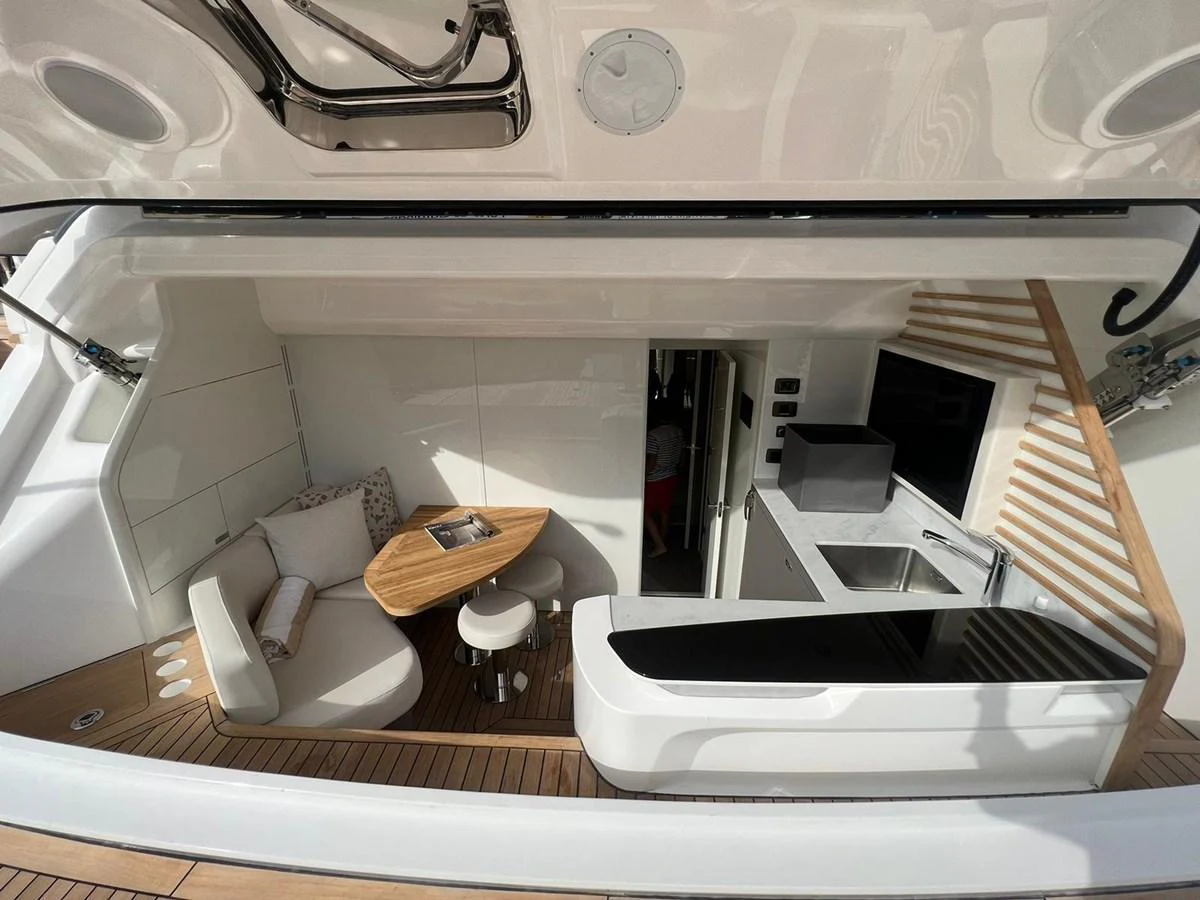 The yacht's galley features a sleek design with modern amenities and a cozy seating area. aboard LEILANI Yacht for Sale