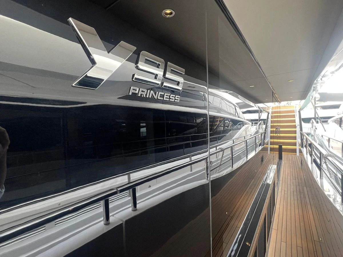 A close-up view of the yacht's sleek exterior showcasing its name and modern design. aboard LEILANI Yacht for Sale