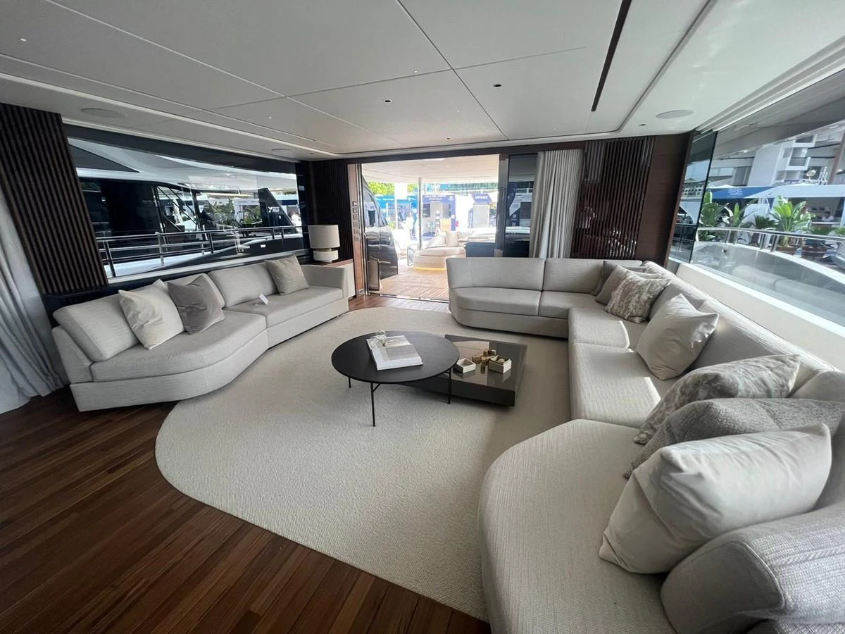 The salon features luxurious seating with elegant decor and ample natural light. aboard LEILANI Yacht for Sale