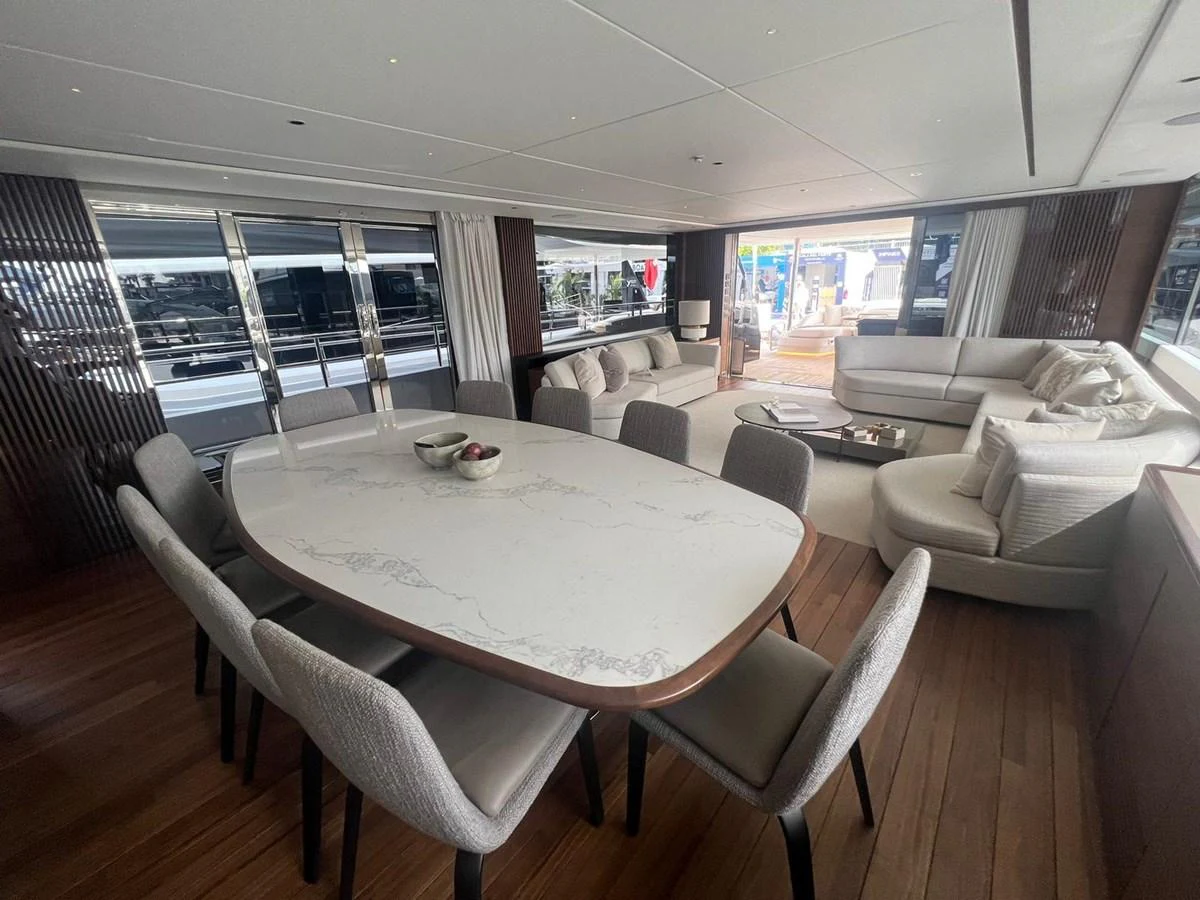 The yacht's salon features a spacious dining area with a large table and comfortable seating, complemented by a cozy lounge area with plush sofas. aboard LEILANI Yacht for Sale