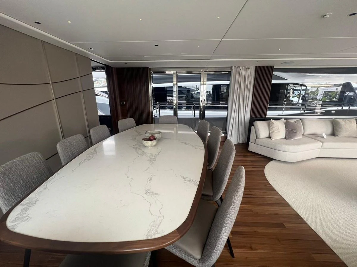 The yacht's dining area features a sleek marble table and comfortable seating, complemented by a modern and elegant design. aboard LEILANI Yacht for Sale