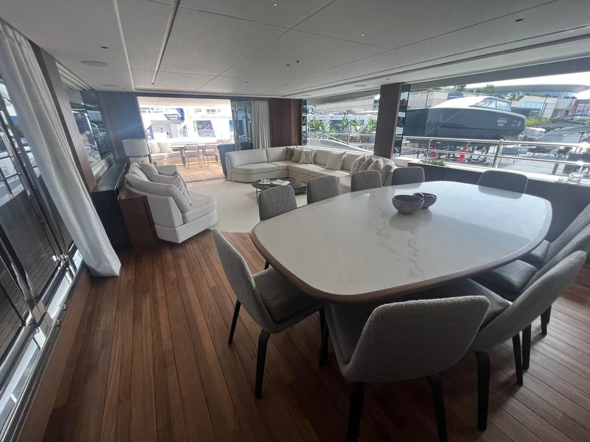 The yacht's salon features a spacious dining area with a large table and comfortable seating, complemented by a cozy lounge area with plush sofas. aboard LEILANI Yacht for Sale