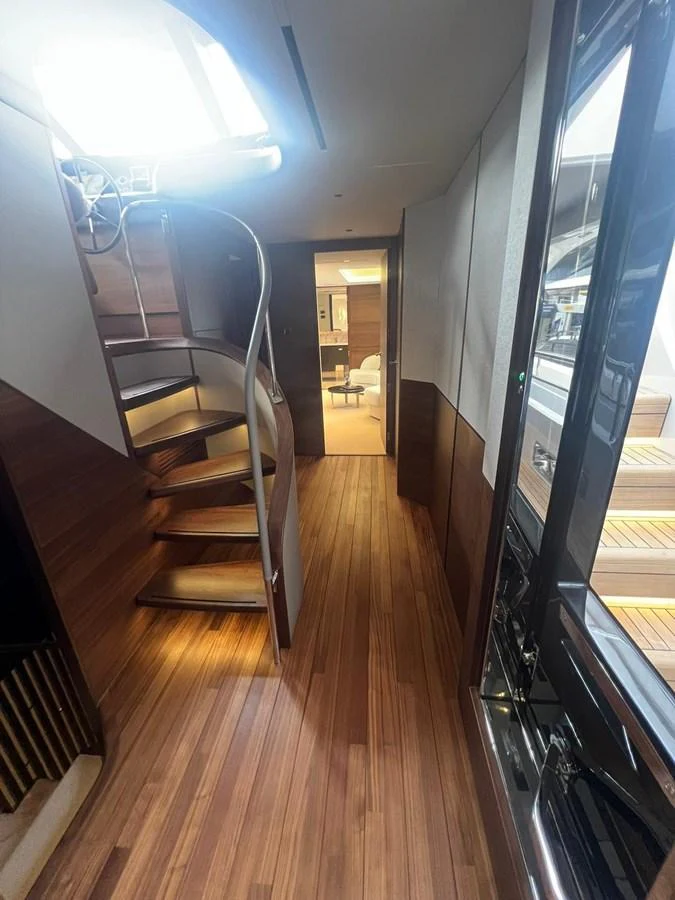 A sleek and modern interior staircase with wooden steps and elegant lighting. aboard LEILANI Yacht for Sale
