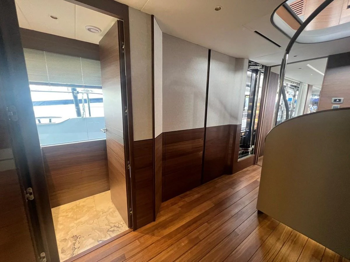 A modern yacht interior featuring wooden flooring and sleek design elements. aboard LEILANI Yacht for Sale