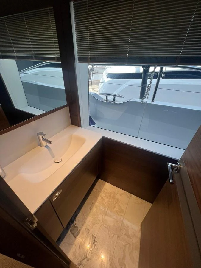 A sleek and modern bathroom with a view of the marina. aboard LEILANI Yacht for Sale