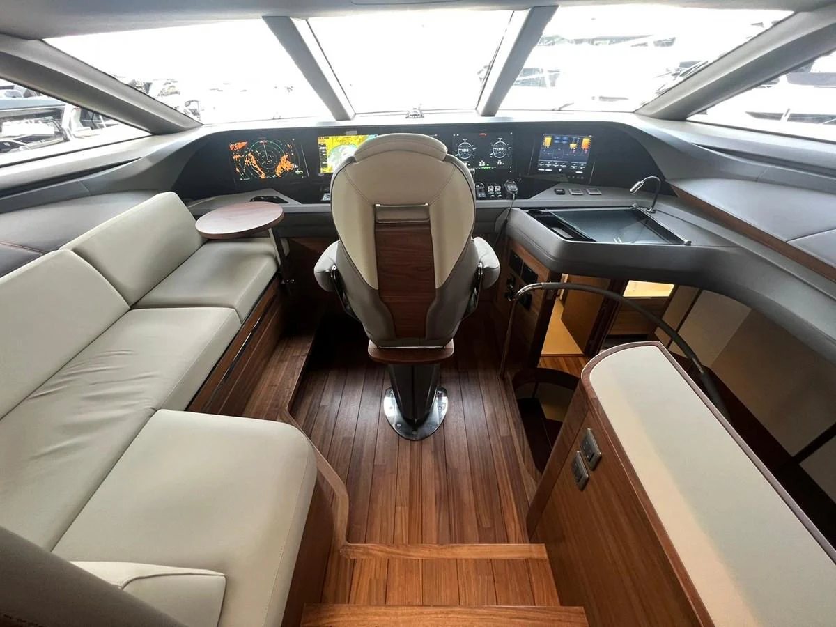 The helm station features modern navigation equipment and comfortable seating with a panoramic view. aboard LEILANI Yacht for Sale