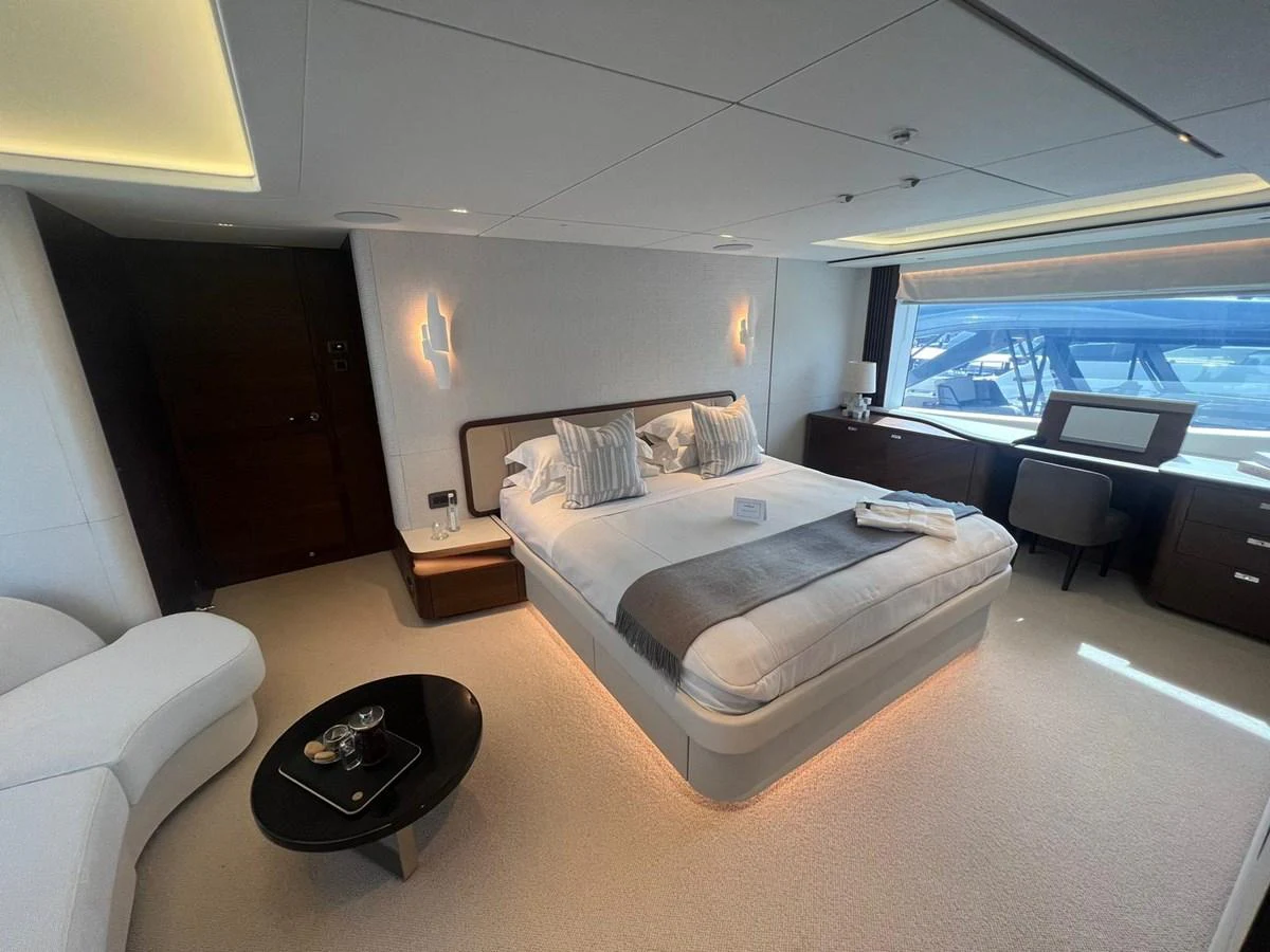 The master stateroom features a luxurious bed, ample natural light, and elegant furnishings. aboard LEILANI Yacht for Sale