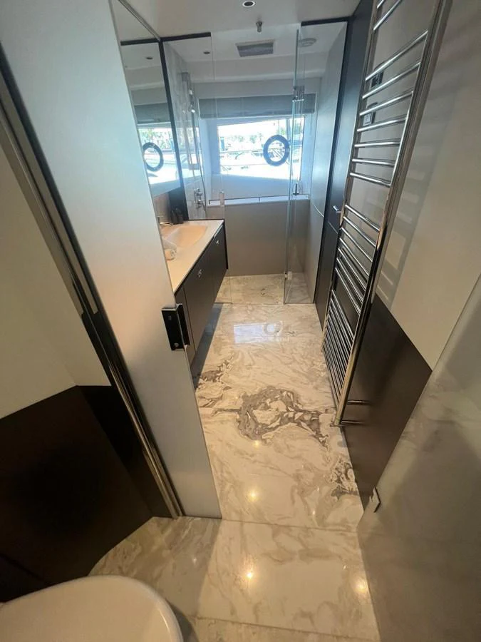The yacht's bathroom features luxurious marble flooring and modern fixtures. aboard LEILANI Yacht for Sale