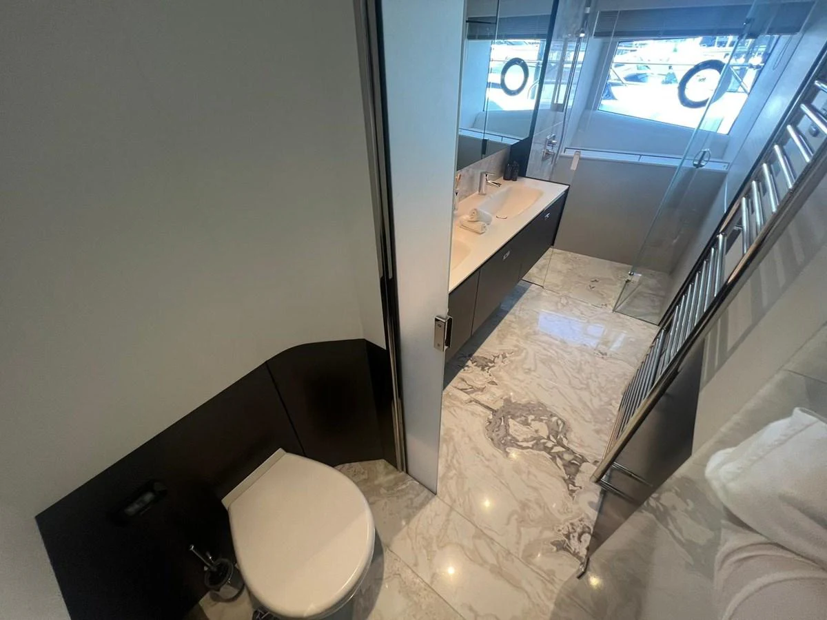 A modern yacht bathroom with sleek fixtures and marble flooring. aboard LEILANI Yacht for Sale