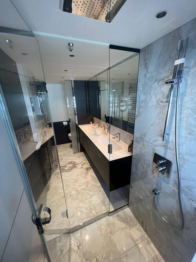The yacht's bathroom features a sleek, modern design with luxurious fixtures and marble accents. aboard LEILANI Yacht for Sale