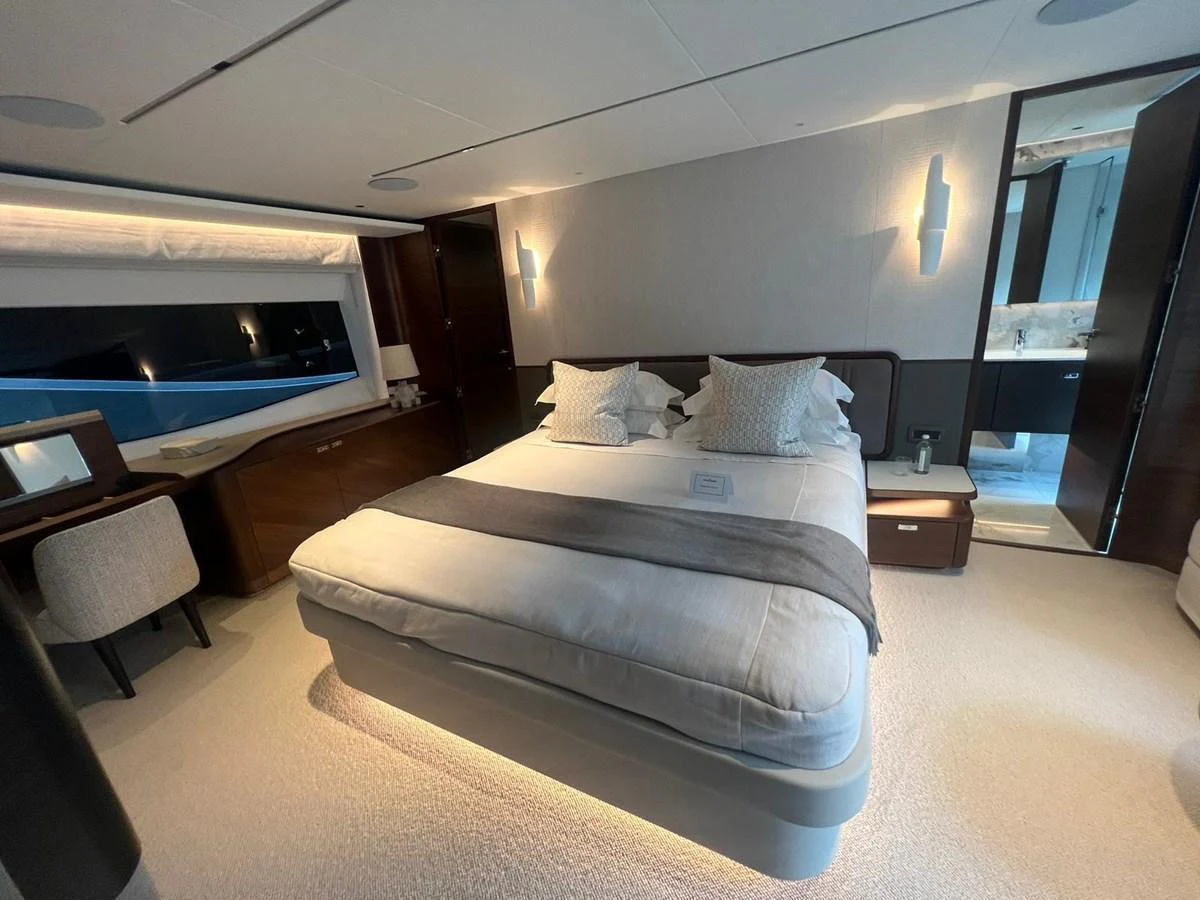 The master stateroom features a luxurious bed with elegant bedding and modern furnishings. aboard LEILANI Yacht for Sale