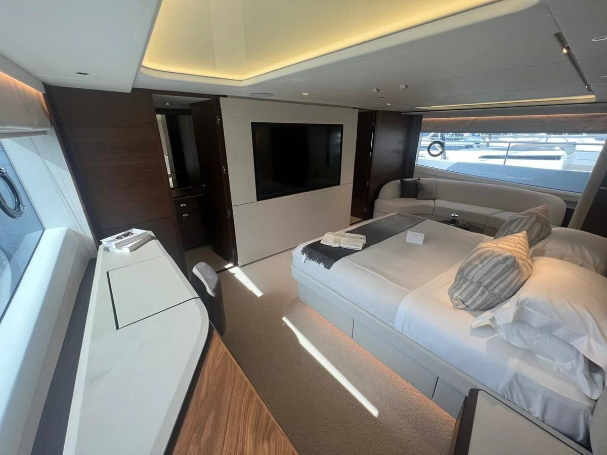 The stateroom features a spacious bed, modern furnishings, and ample natural light. aboard LEILANI Yacht for Sale