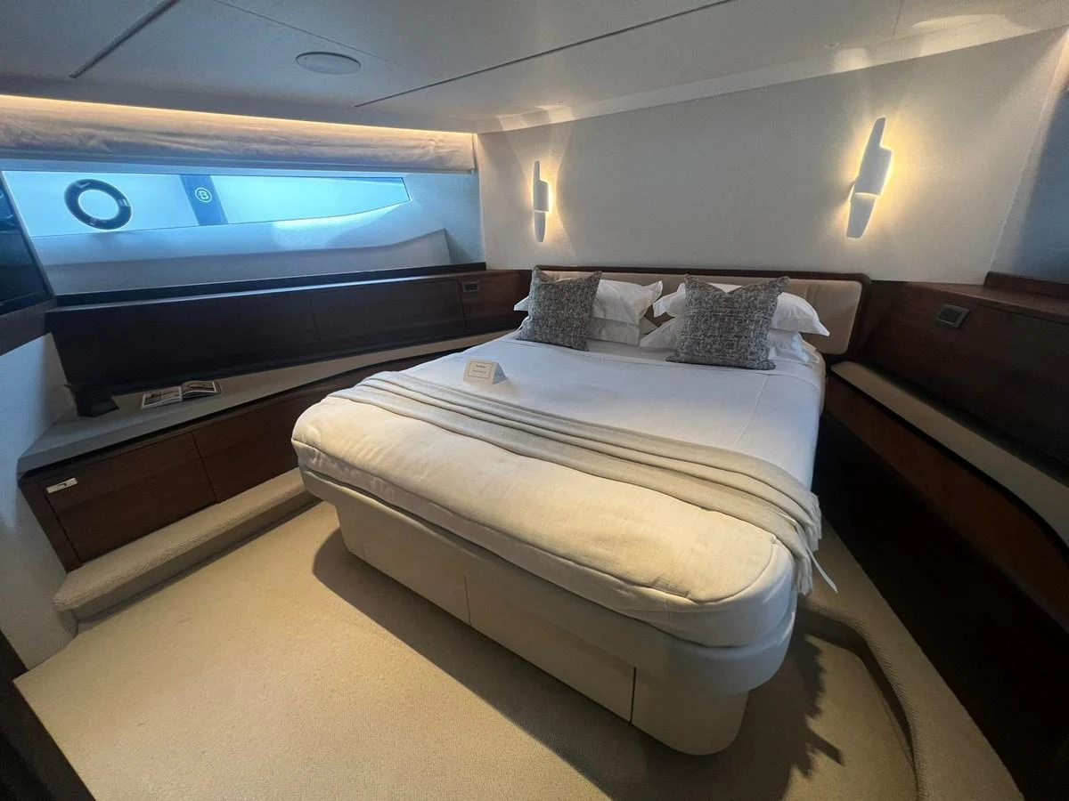 The stateroom features a luxurious bed with elegant lighting and ample storage space. aboard LEILANI Yacht for Sale