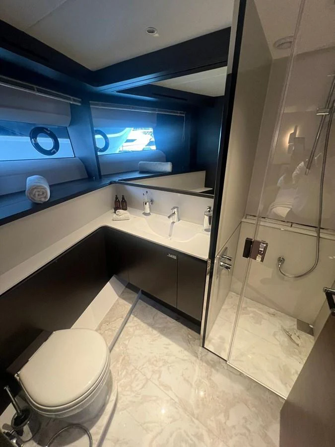 A sleek and modern yacht bathroom featuring a glass-enclosed shower and elegant fixtures. aboard LEILANI Yacht for Sale