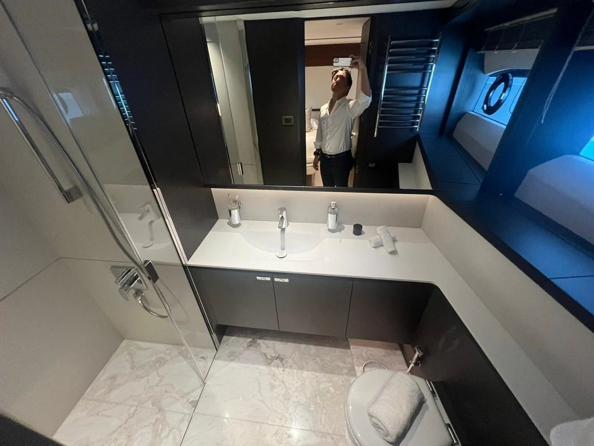 A sleek and modern yacht bathroom with elegant fixtures and a spacious layout. aboard LEILANI Yacht for Sale